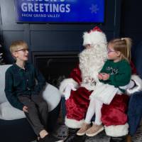 Boy and girl talk with Santa